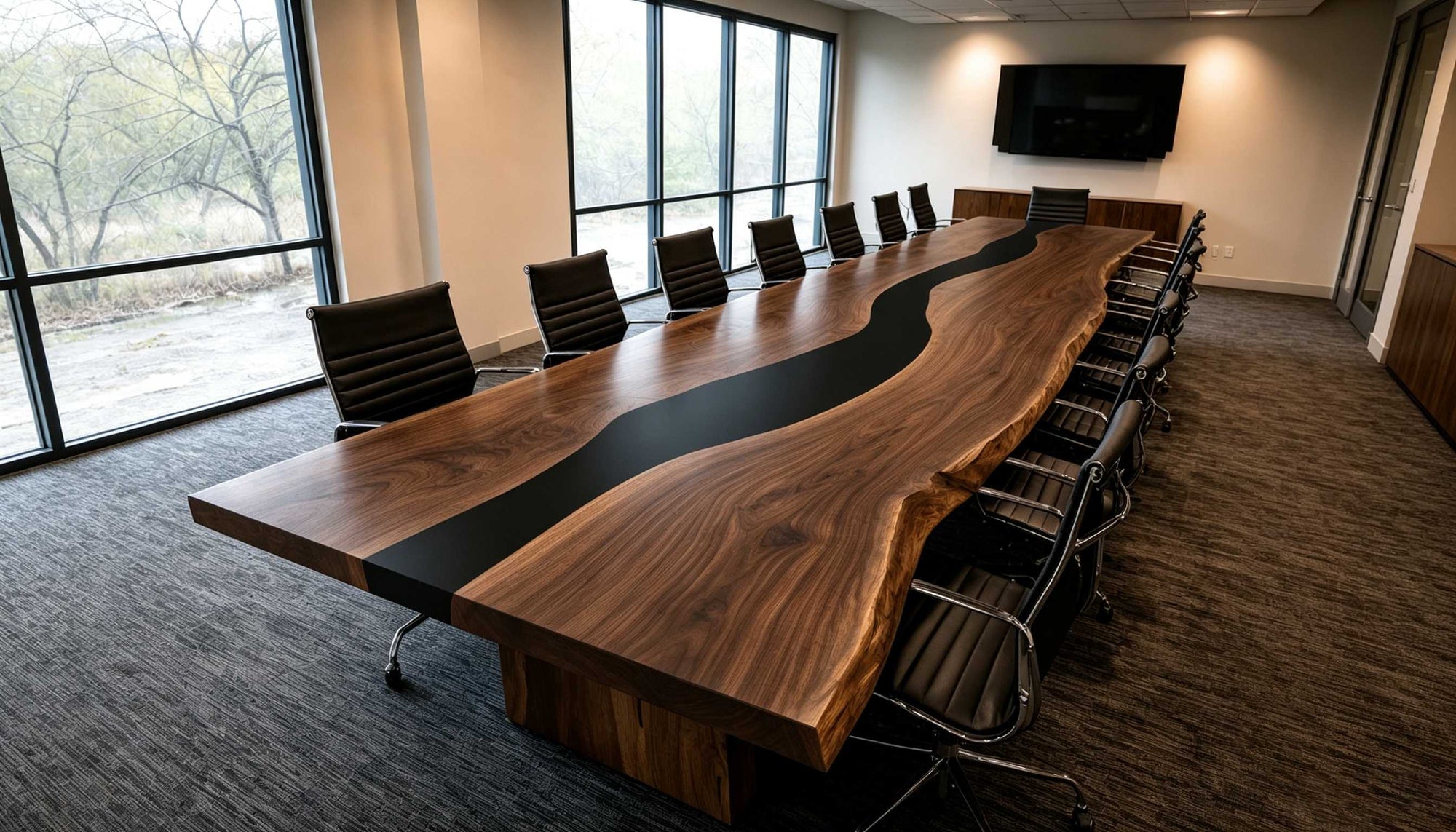 Modern office conference room with a long wooden table and chairs.