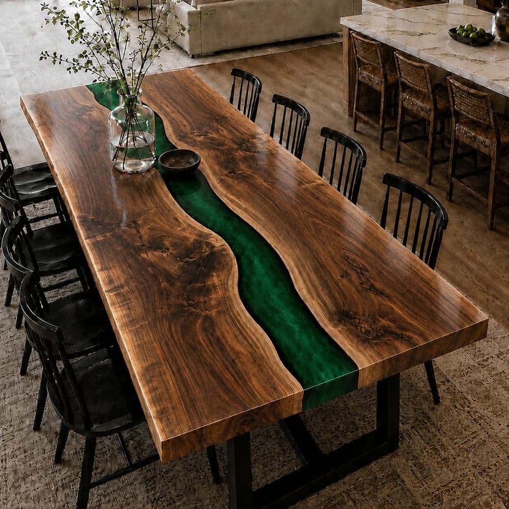 Long-form walnut resin entertaining table flanked by eight modern matte black wooden spindle dining chairs on a textured rug