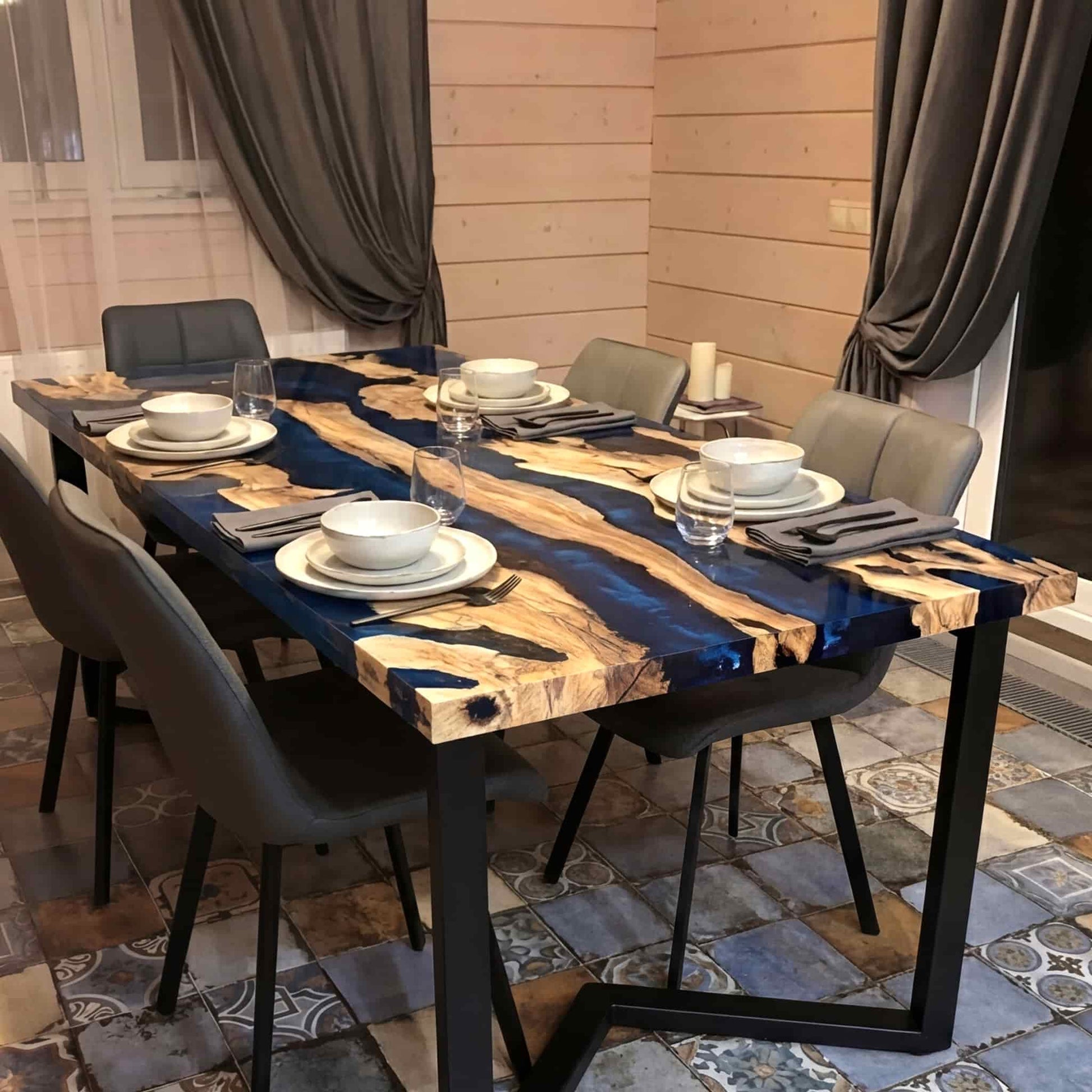 Overhead view of a polished premium hardwood table with a liquid glass deep sapphire resin flow.