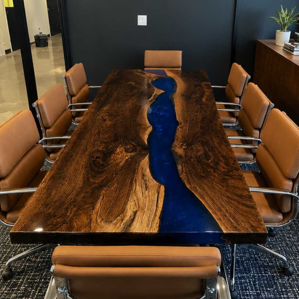 Custom handcrafted boardroom table showcasing intricate burl wood patterns and a smooth, vibrant blue epoxy river inlay, highlighting artisan craftsmanship