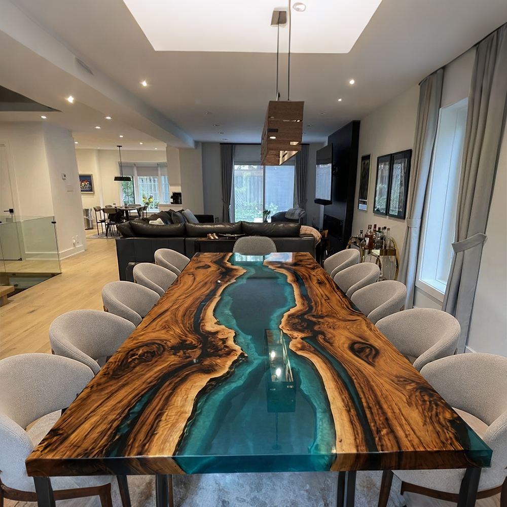 Large black walnut gathering table with flowing blue epoxy river and natural live edge detail
