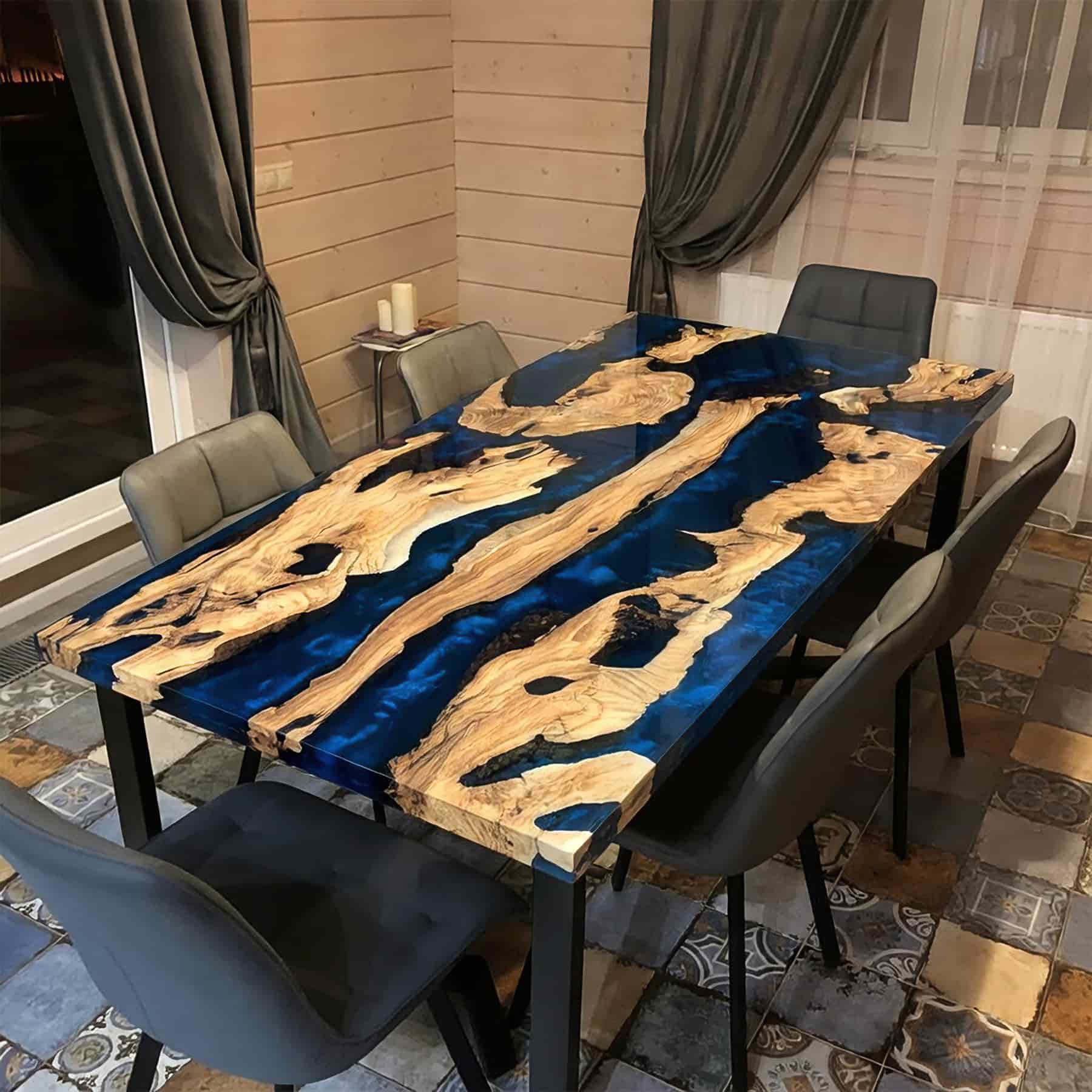 Luxury live edge ash wood dining table with a swirling deep blue metallic epoxy resin river.