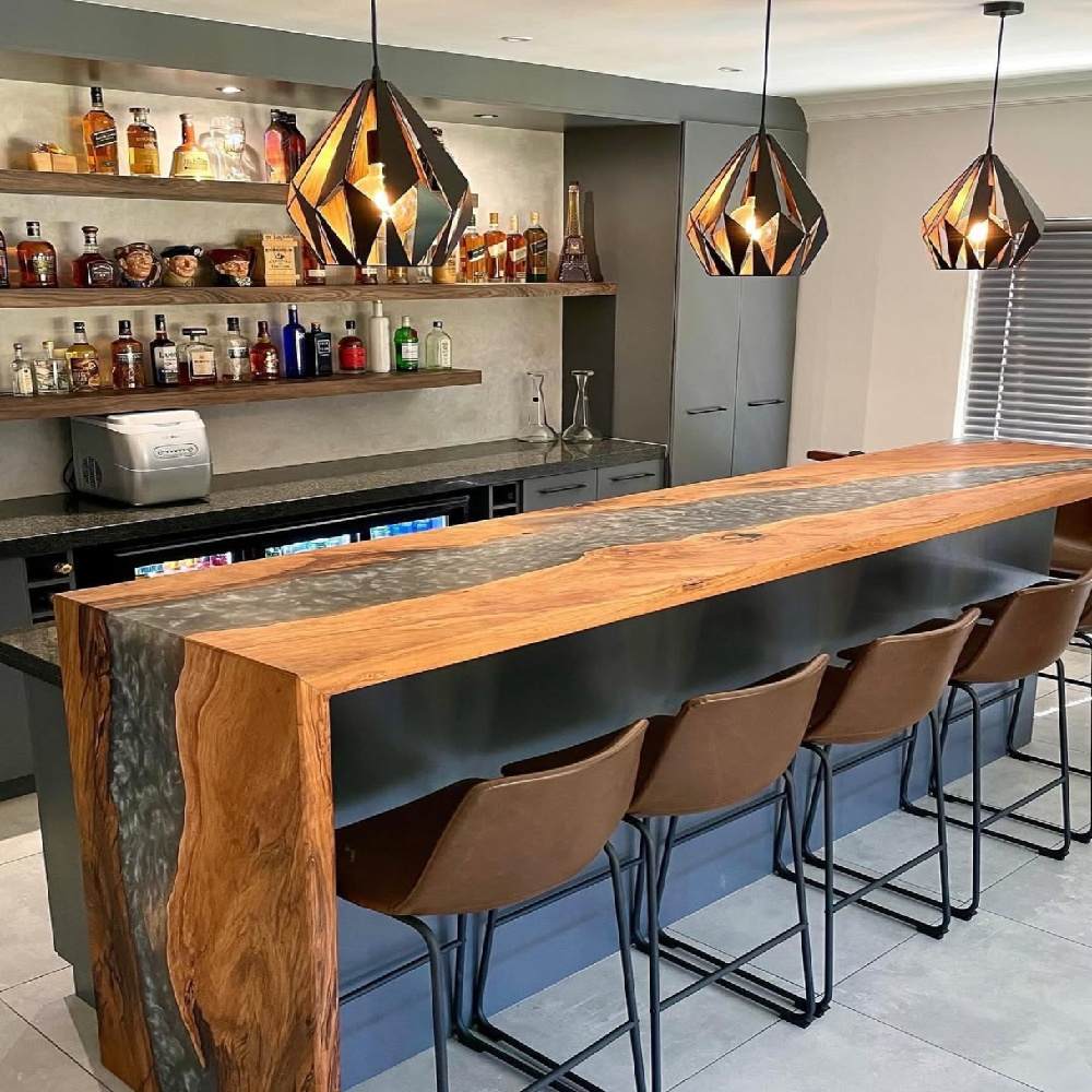 Complete home bar furniture set featuring live edge silver swirl epoxy walnut counter and matching solid walnut saddle bar stools with brass footrests