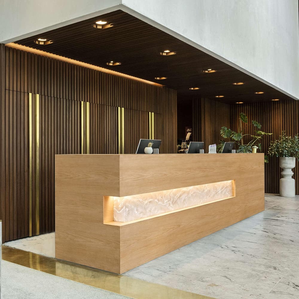 Contemporary ash welcome desk with a clean profile and white resin insert