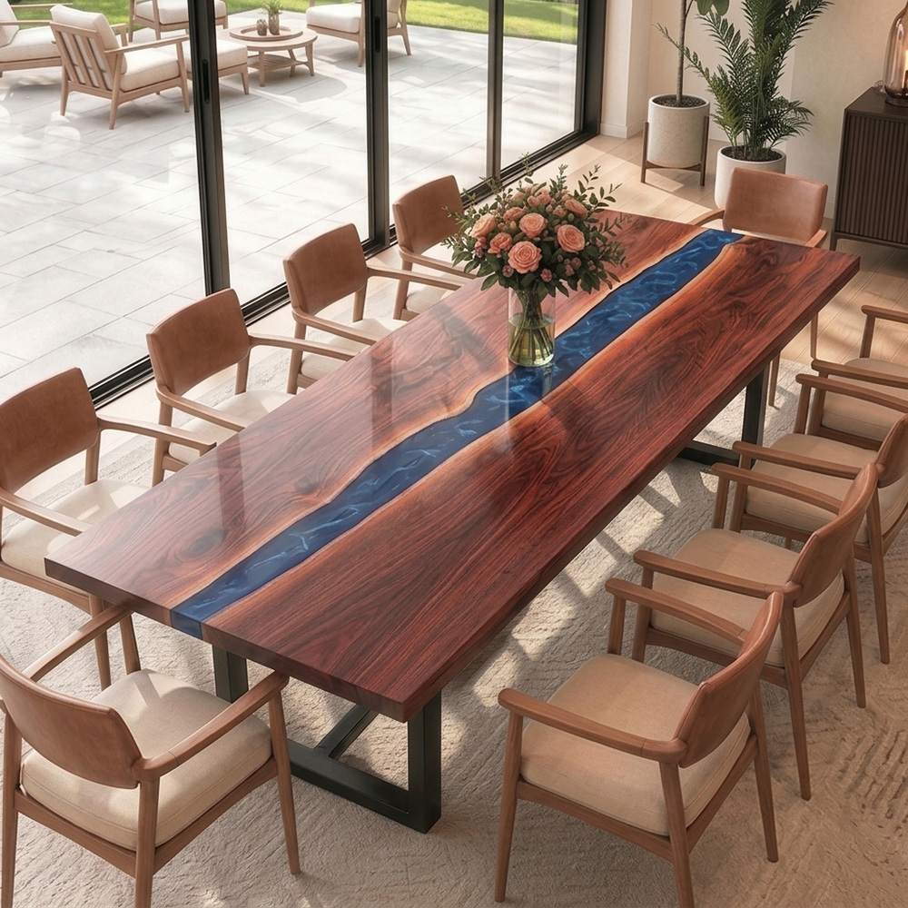 Custom ocean blue epoxy river table with a rectangular solid wood top and modern black metal base in a bright dining space.