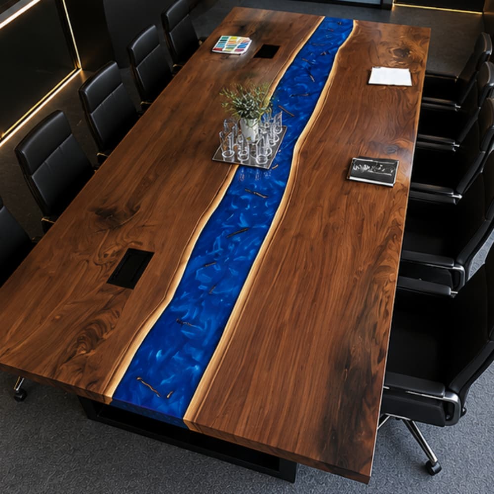 Bespoke L-shaped conference table with rich black walnut grain and a vibrant blue epoxy river, equipped with cable management for professional meeting rooms