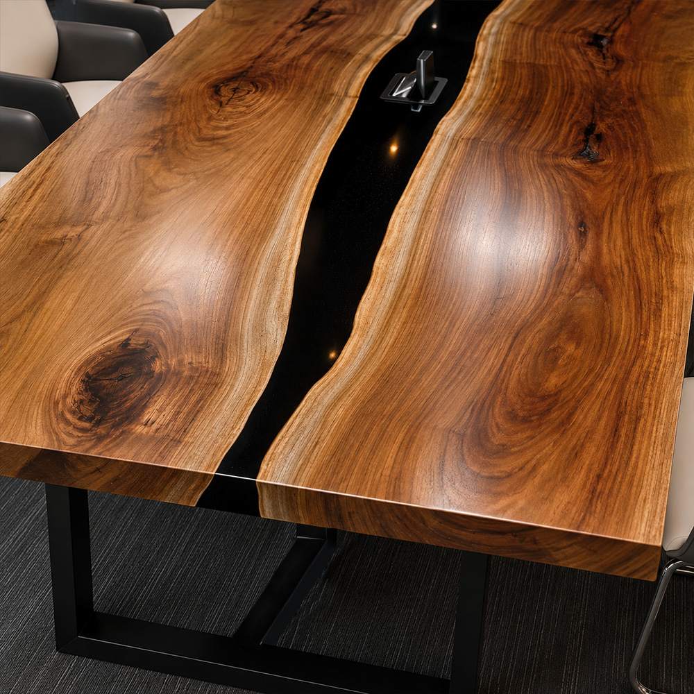 Opaque black epoxy river set between live edge walnut slabs on a custom boardroom table for executive offices and meeting spaces