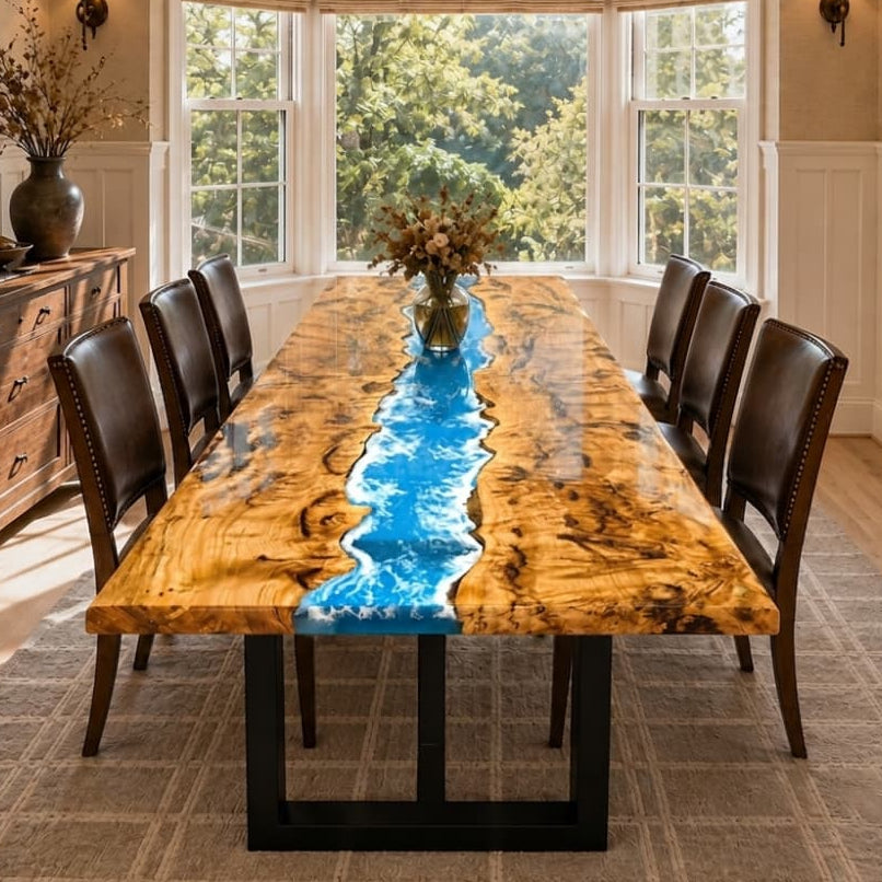 Custom poplar ocean blue epoxy dining table with live edge wood grain in a bright dining room