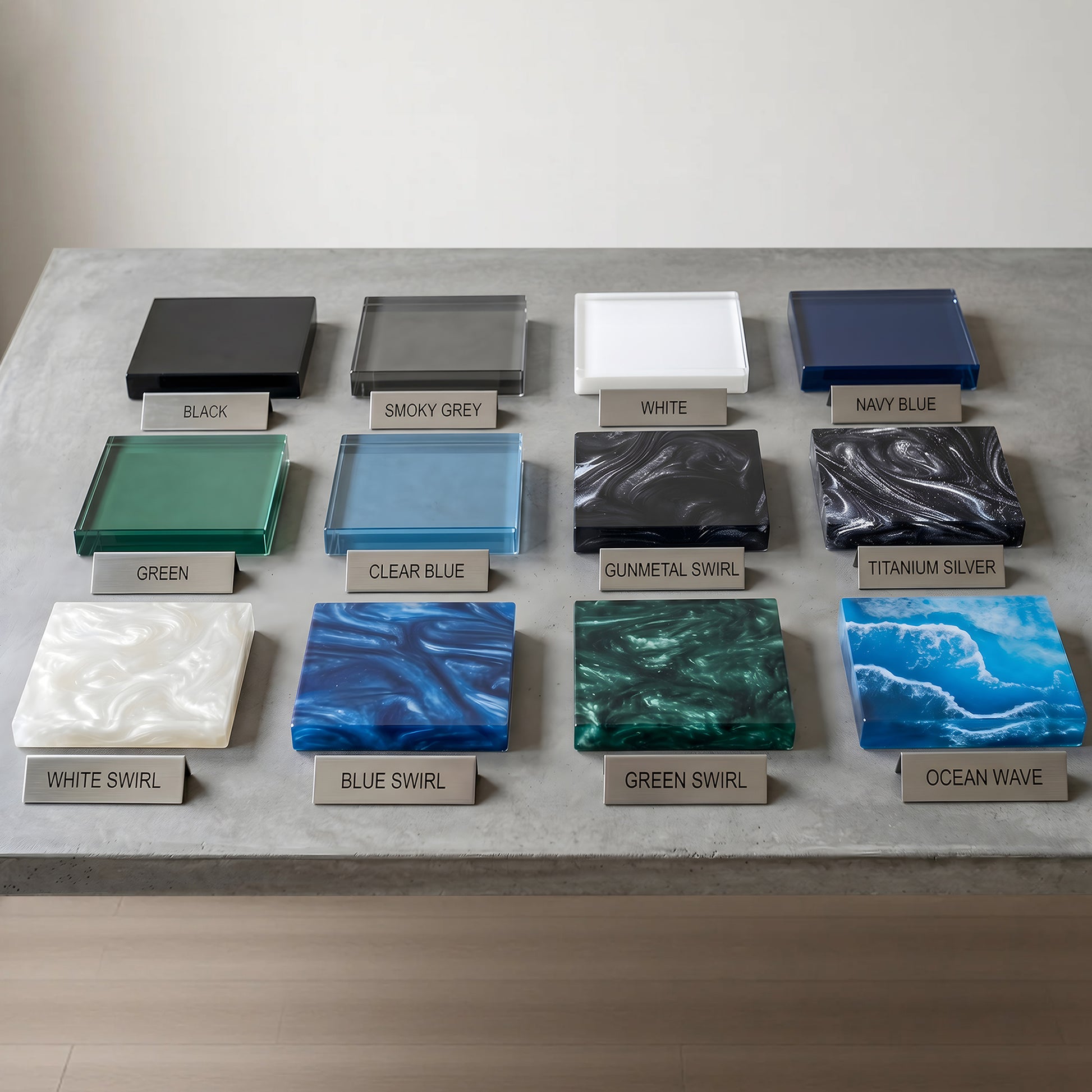 Collection of glass tiles in various colors and patterns on a concrete surface.