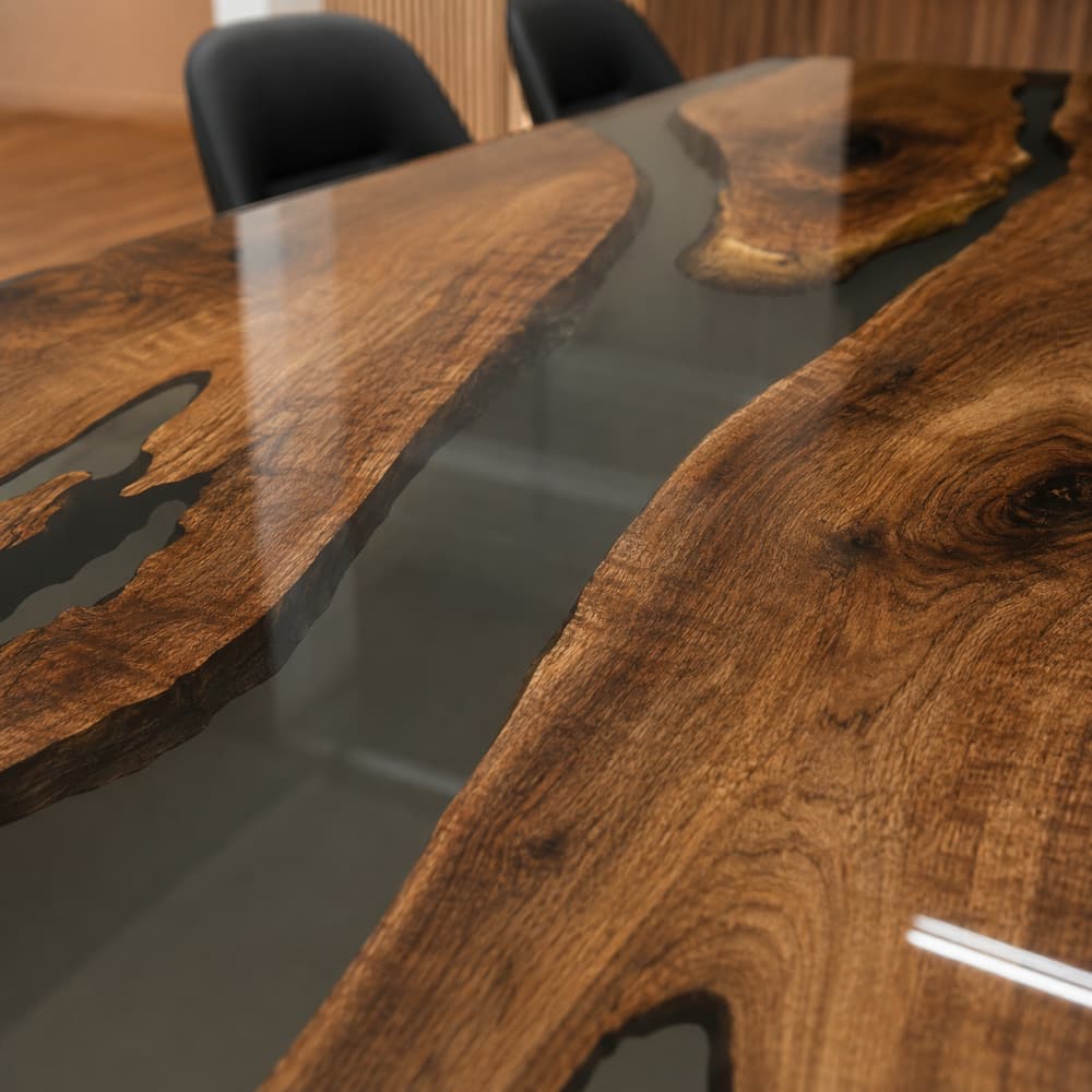 Top view of premium dark black walnut wood grain integrated with a semi-transparent charcoal gray epoxy resin river