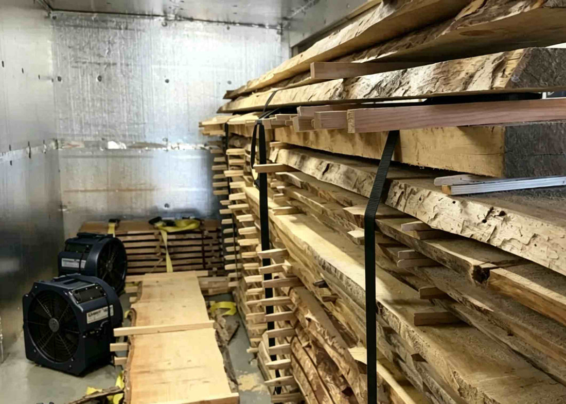 Stacked walnut wood slabs inside an industrial kiln for moisture drying