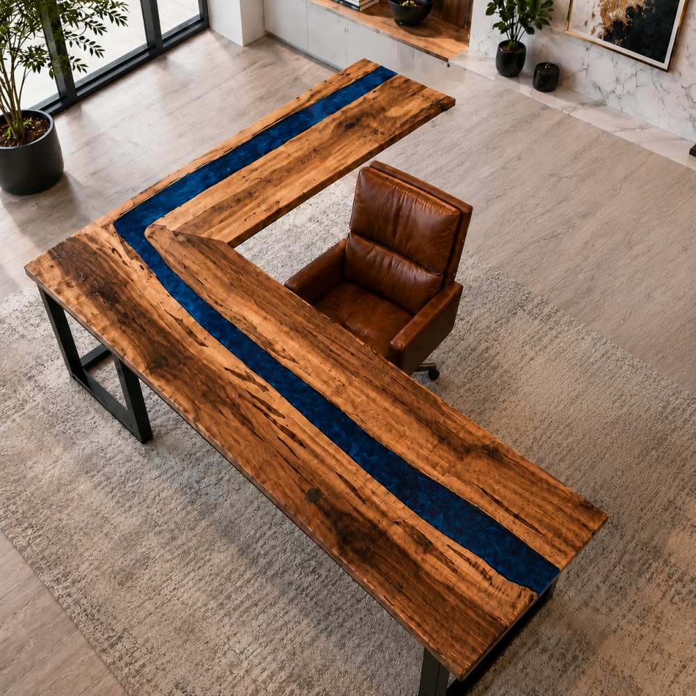 Styled executive office vignette featuring walnut deep blue epoxy L desk matched with dark walnut side credenza, brass table lamp and stacked hardcover books